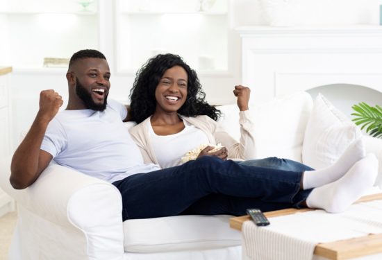 black-millennial-couple-watching-sports-on-KM7BVDR